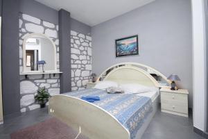 a bedroom with a bed and a mirror at Apartments with a parking space Hvar - 8810 in Hvar