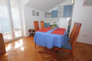 a kitchen with a table and chairs and a refrigerator at Apartments with a parking space Cavtat, Dubrovnik - 9032 in Cavtat