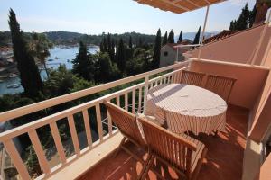 a balcony with a table and chairs and a view at Apartments with a parking space Cavtat, Dubrovnik - 9032 in Cavtat