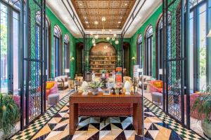 a room with a table and chairs and a library at 2BR Designer's villa at Cicada Huahin in Hua Hin