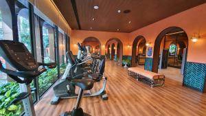 a gym with treadmills and exercise bikes in a room at 2BR Designer's villa at La Habana Huahin in Hua Hin
