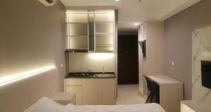 a small kitchen with a sink and a counter at Apartemen Borneo Bay City (1 Bedroom Studio) in Klandasan Kecil +5 photos