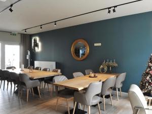 a dining room with two tables and a christmas tree at Splendid Holiday Home in Le Tignet South with Garden in Eisden