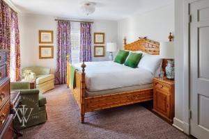 a bedroom with a large bed and a window at Wickwood Inn in Saugatuck