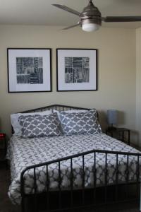 a bedroom with a bed and two pictures on the wall at New Family Friendly Stay! No Checkout Work! in College Station