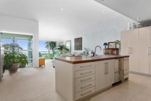 a kitchen with a sink and a counter top at Pohutukawa Paradise - Ōhope Holiday Apartment in Ohope Beach