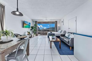 a living room with a couch and a table at Ocean View Apartment 49 in Airlie Beach