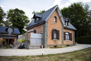 a brick house with a black roof at La Sentinelle Gite in Spa