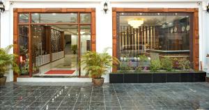 a store front with potted plants in front of it at Vang Vieng Freedom Star's Hotel in Vang Vieng
