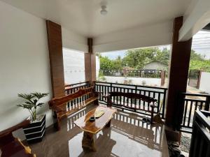 a room with a table and chairs on a balcony at Tagaytay Transient House, 4 bedrooms, billiard in Indang