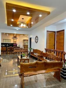 a large living room with wooden furniture and a table at Tagaytay Transient House, 4 bedrooms, billiard in Indang