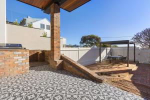 a patio with a table and a gazebo at The Stables at the Hill in Newcastle