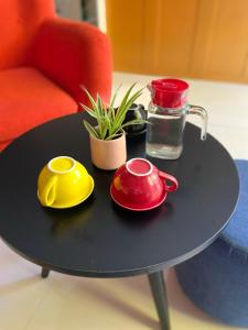 a black table with two red and yellow dishes on it at Maison Khoi Homestay in Hoi An