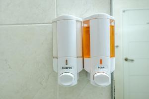 two toasters are hanging on a wall in a bathroom at Samhaein Tourist Hotel in Jeju