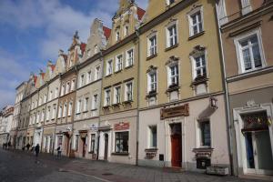 a row of buildings on a city street at Red Bike Apart's in Opole