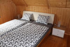 a bedroom with a bed and two pillows at Chata Brusno in Brusno
