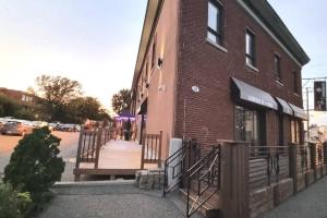 a brick building with a wooden walkway next to a building at Cozy Spacious 1-BDR Studio #8. FREE Parking in Gatineau +5 photos