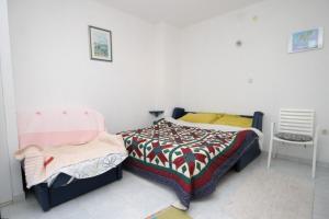 a bedroom with a bed with a colorful comforter at Apartments with a parking space Vis - 8938 in Vis