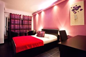 a bedroom with a bed with a red blanket at Luxury villa with a swimming pool Vis - 8922 in Vis