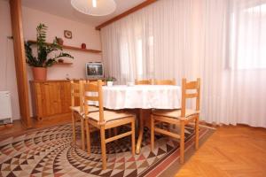 a dining room with a white table and chairs at Apartments by the sea Vis - 8875 in Vis