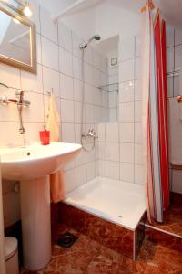 ein Badezimmer mit einem Waschbecken, einer Dusche und einer Badewanne in der Unterkunft Apartments by the sea Vis - 8932 in Vis