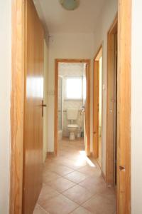 a hallway of a bathroom with a toilet and a window at Apartments with a parking space Brgujac, Vis - 8919 in Rukavac