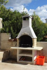 a pizza oven sitting on top of a wall at Apartments by the sea Brna - Vinacac, Korcula - 9152 in Smokvica