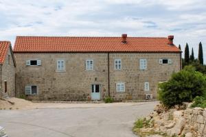 a large brick building with a red roof at Apartments with a parking space Mocici, Dubrovnik - 9081 in Mlini