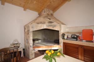 a kitchen with a large stone oven in a room at Apartments with a parking space Podspilje, Vis - 8915 in Vis