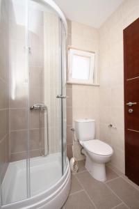 a bathroom with a toilet and a glass shower at Apartments by the sea Zavalatica, Korcula - 9138 in Zavalatica +23 photos