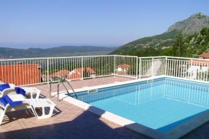a swimming pool with a view of a mountain at Holiday house with a swimming pool Dubravka, Dubrovnik - 9101 in Gruda