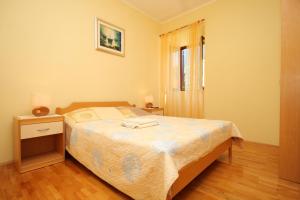 a bedroom with a bed and a window at Holiday house with a swimming pool Dubravka, Dubrovnik - 9101 in Gruda