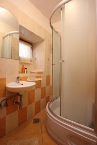 a bathroom with a shower and a sink and a tub at Apartments by the sea Vis - 8930 in Vis +20 photos