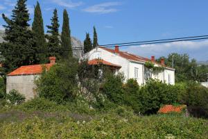 a white house with trees and bushes at Apartments with a parking space Srebreno, Dubrovnik - 9028 in Mlini