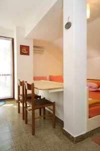 a room with a table and chairs and a bed at Apartments with a parking space Srebreno, Dubrovnik - 9028 in Mlini