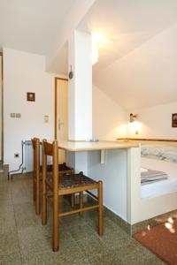 a room with a table and chairs and a bed at Apartments with a parking space Srebreno, Dubrovnik - 9028 in Mlini
