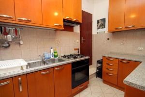 a kitchen with a sink and a stove top oven at Rooms by the sea Zaton Mali (Dubrovnik) - 8997 in Zaton