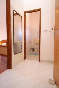 a bathroom with a mirror and a sink and a toilet at Apartments with a parking space Cavtat, Dubrovnik - 8993 in Mlini