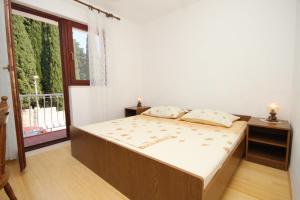 a bedroom with a bed and a large window at Apartments with a parking space Cavtat, Dubrovnik - 8993 in Mlini