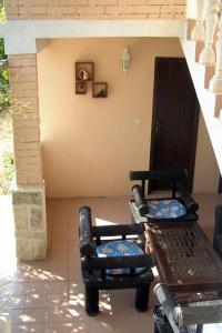 two chairs and a table on a patio at Apartments with a parking space Rukavac, Vis - 8920 in Rukavac