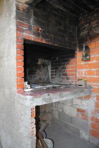 a brick fireplace in a room with a brick wall at Apartments and rooms by the sea Molunat, Dubrovnik - 8964 in Gruda