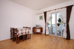 a dining room with a table and a sliding glass door at Apartments by the sea Brna, Korcula - 9159 in Smokvica