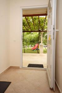 una puerta abierta con vistas a un parque infantil en Apartments for families with children Mlini, Dubrovnik - 8970 en Mlini