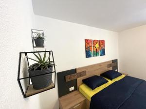 a bedroom with a bed and two pictures on the wall at Apartments and rooms pri Bašlju in Cerkno