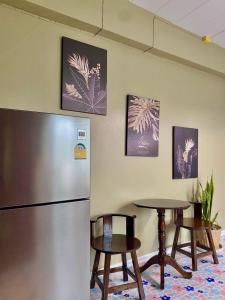 a kitchen with a refrigerator and a table at ภูมินทร์โฮมน่าน in Nan +20 photos