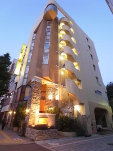 a large building with lights on the side of it at Hotel Mju-Adult Only in Tokyo