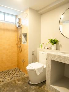 a bathroom with a toilet and a sink at Art Gallery Apartment@Chiang Mai train station in Chiang Mai