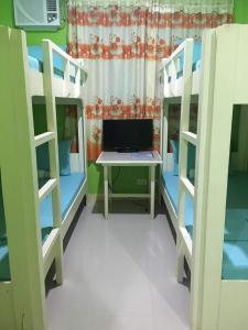a room with two bunk beds and a desk at Twin AP Homes in Boracay