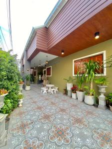 a courtyard with potted plants in a building at ภูมินทร์โฮมน่าน in Nan