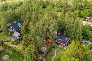 an aerial view of a house in a forest at White & Black in Kołczewo